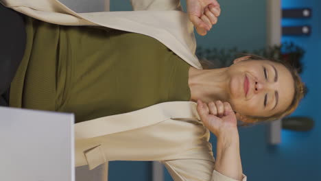 Vertical-video-of-Home-office-worker-woman-yawns-and-relaxes-at-the-camera.
